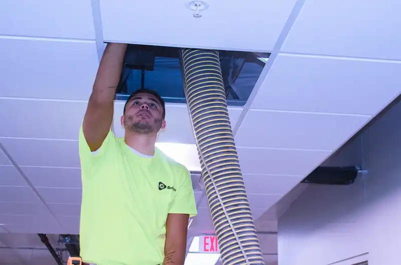 BalCon Tab Technician adjusting air dampers.