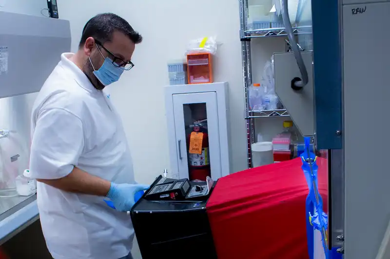 BalCon Tab Technician and examining a biological safety cabinet